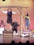 woman stands on top of wood chest