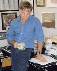 Stephen Schwartz in his office, holding a cup of tea.