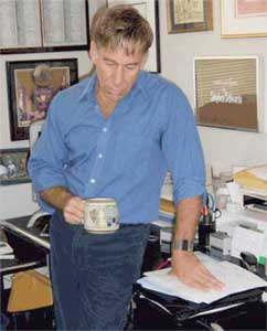 Stephen Schwartz in his office, holding a cup of tea.